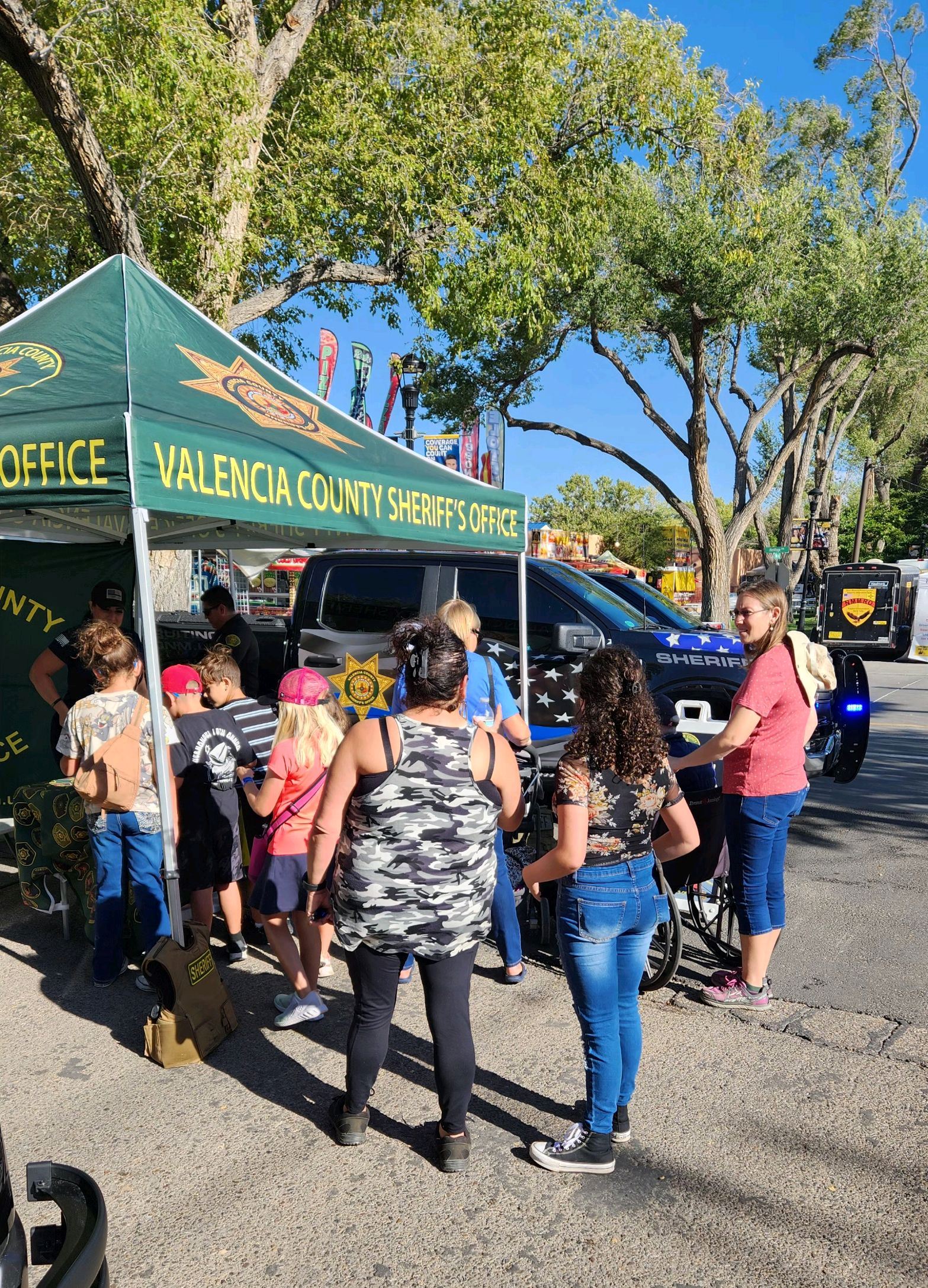 group gathers at the Valencia County Sheriff's Office booth